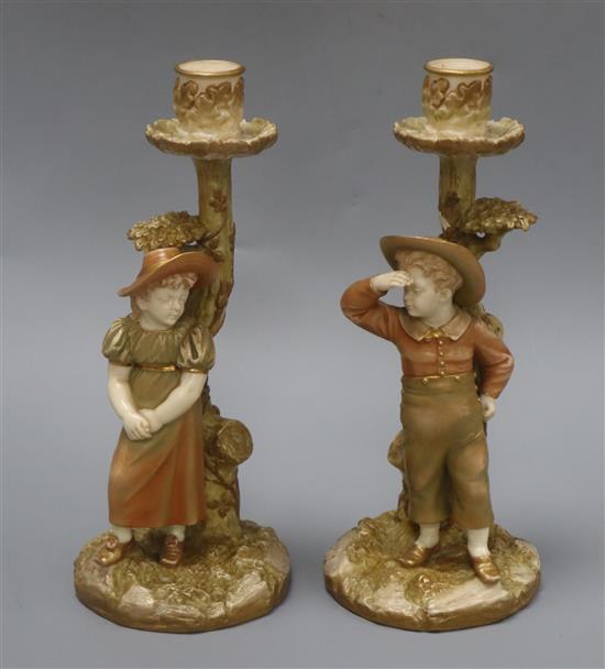 A pair of Royal Worcester Hadley candlesticks height 25.5cm
